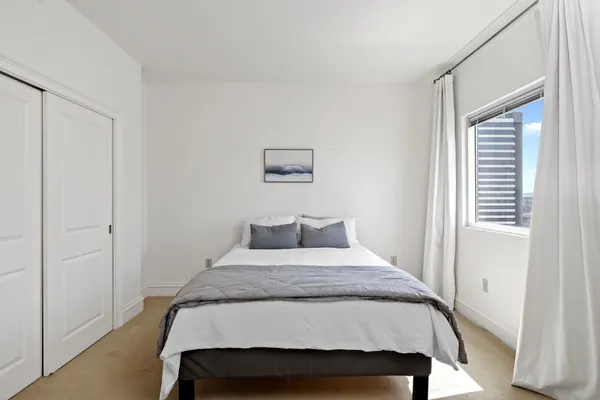 a bedroom with a bed and a window