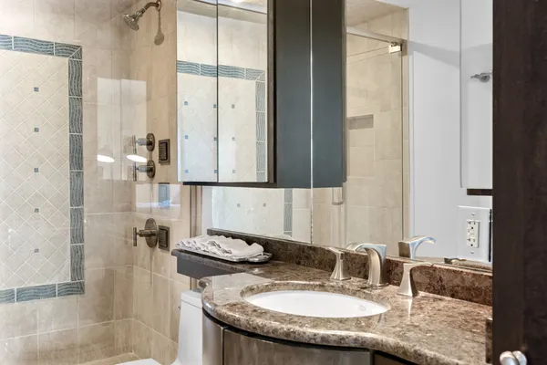 a bathroom with a granite countertop sink and a mirror