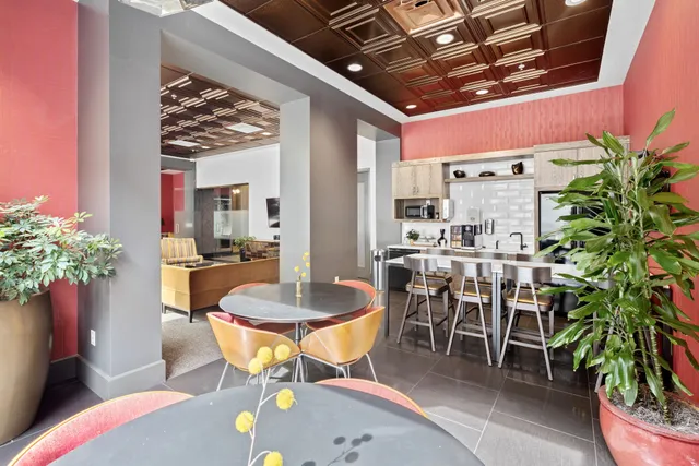 a view of a dining room with furniture and a potted plant