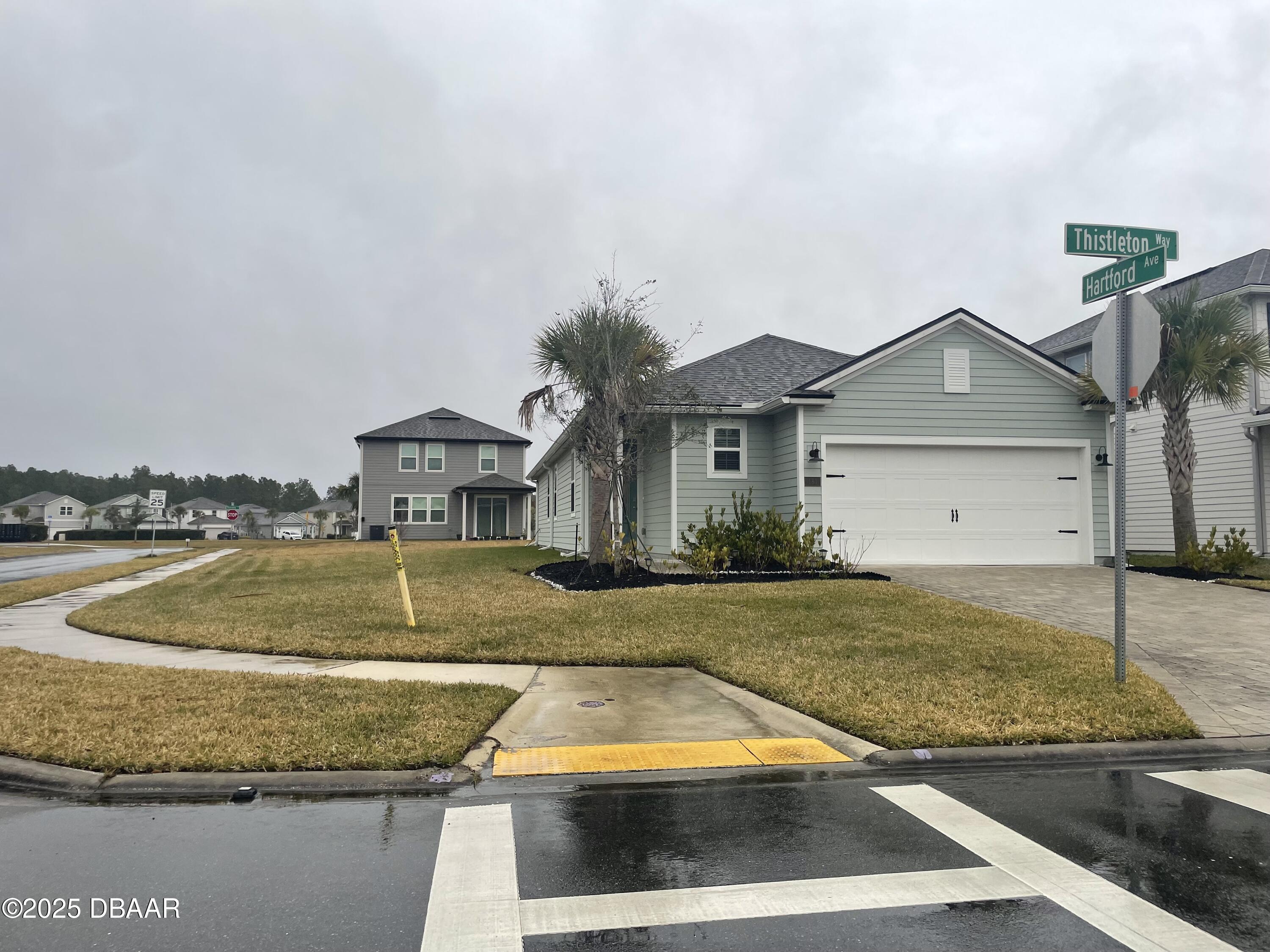 a view of a house with pool and a yard