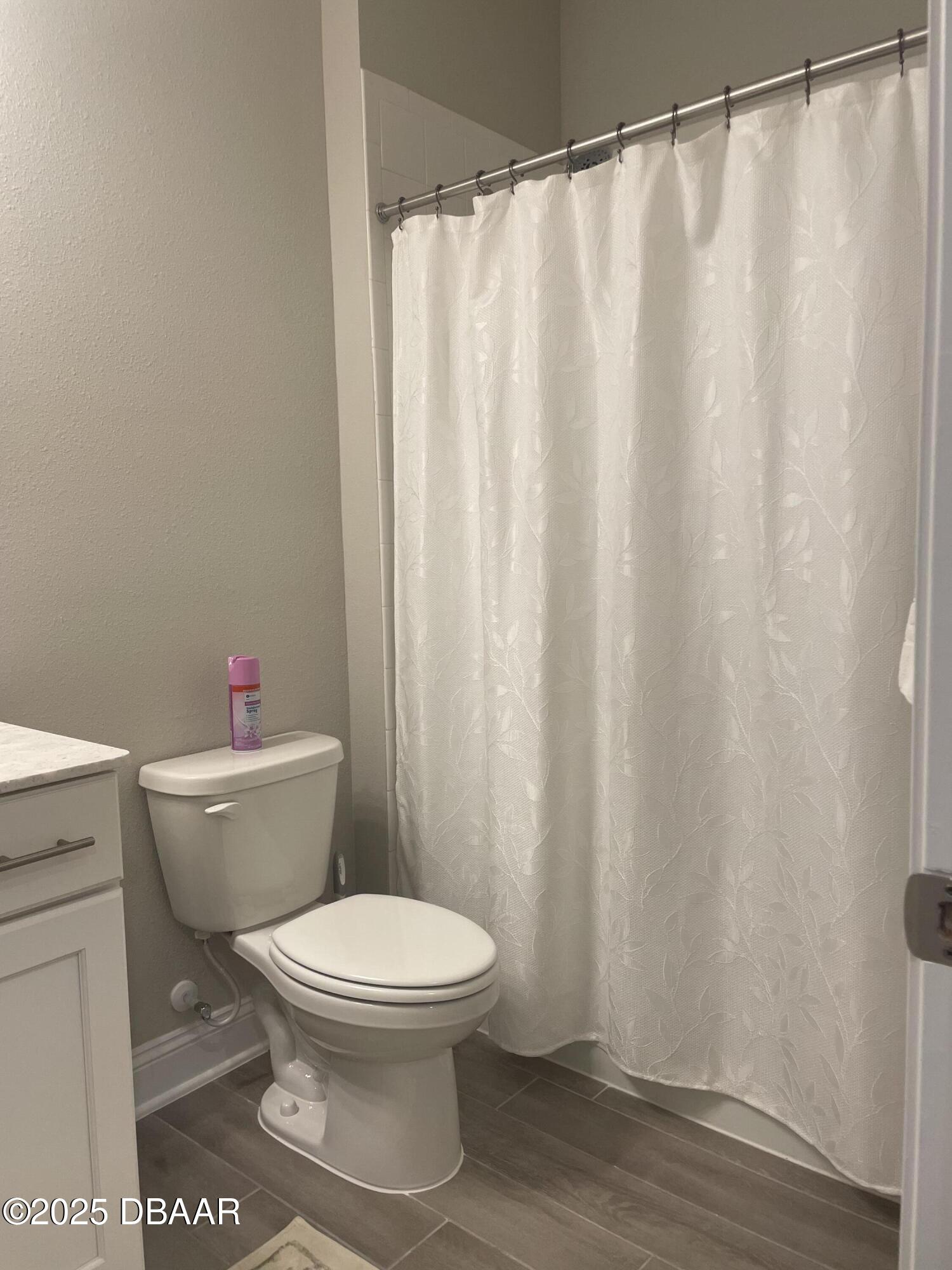 181 Thistleton Way St. Augustine, FL 32092 - Photo 15 of 31 a white toilet sitting next to a shower curtain