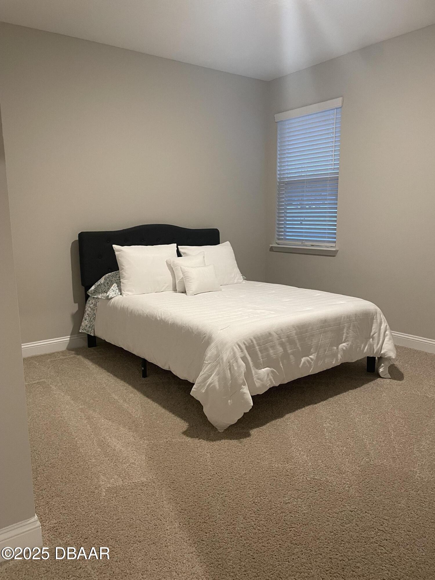 181 Thistleton Way St. Augustine, FL 32092 - Photo 18 of 31 a bedroom with a bed and window