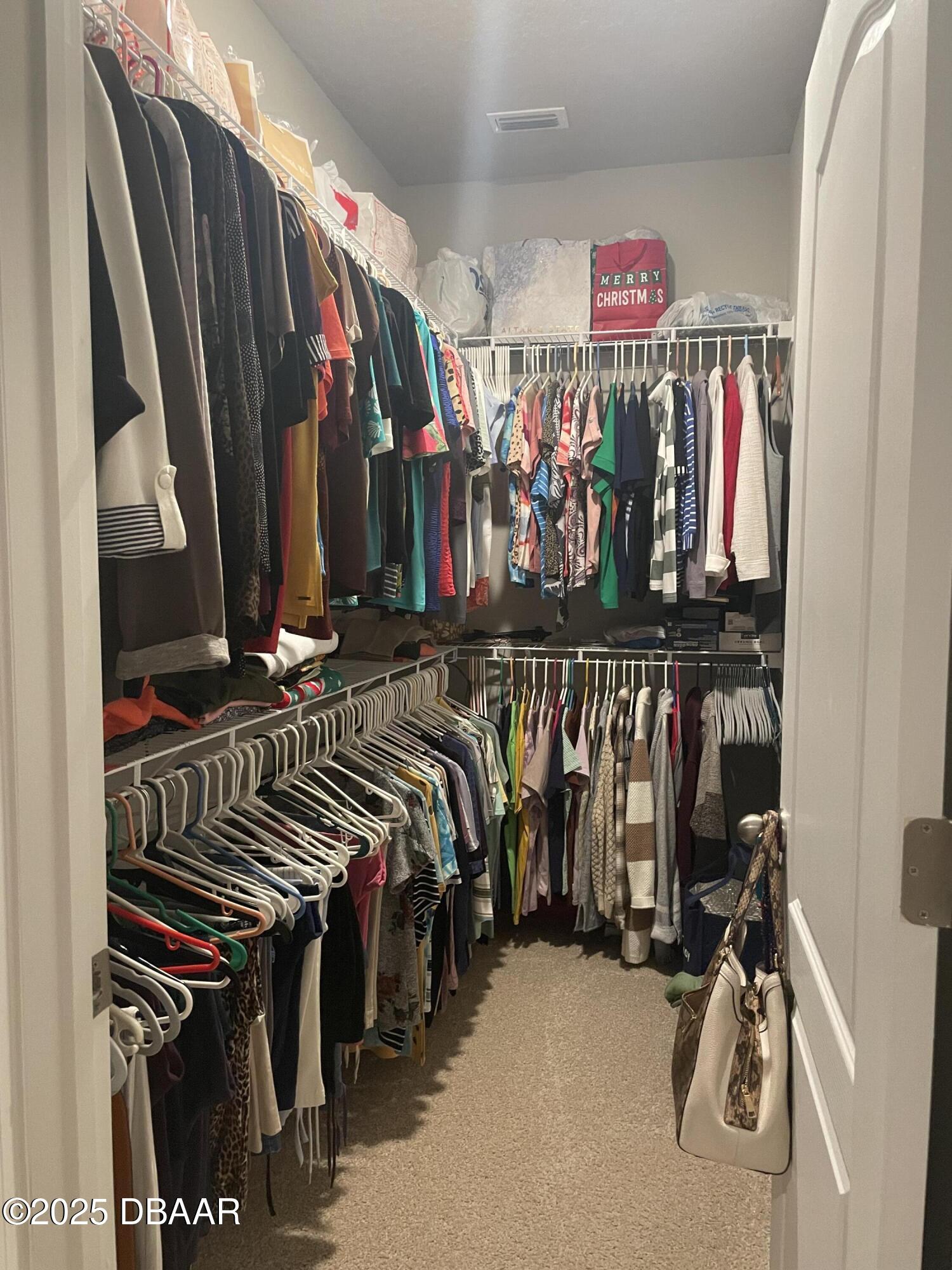 181 Thistleton Way St. Augustine, FL 32092 - Photo 19 of 31 a view of walk in closet with clothes