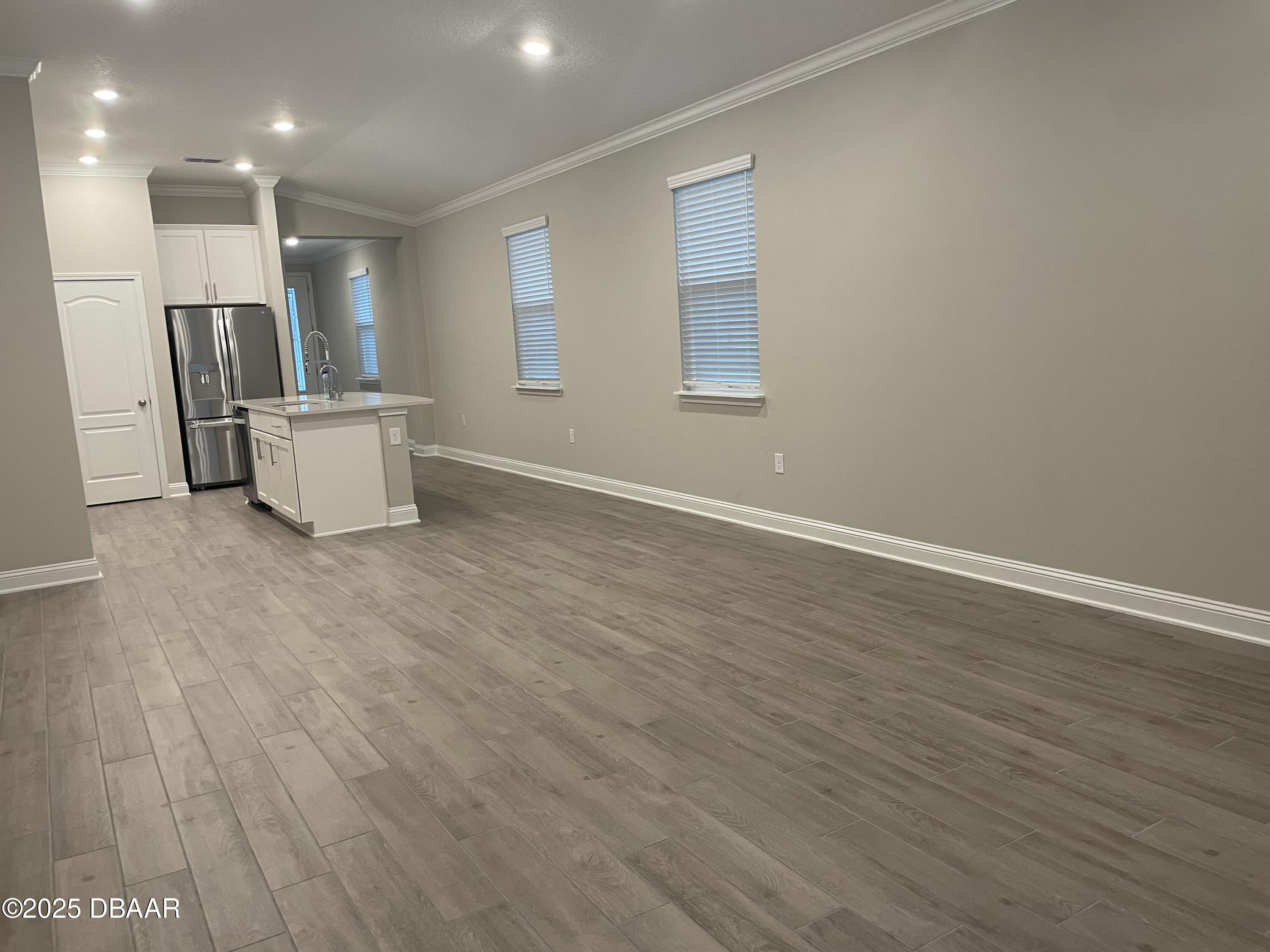 181 Thistleton Way St. Augustine, FL 32092 - Photo 26 of 31 an empty room with wooden floor and window