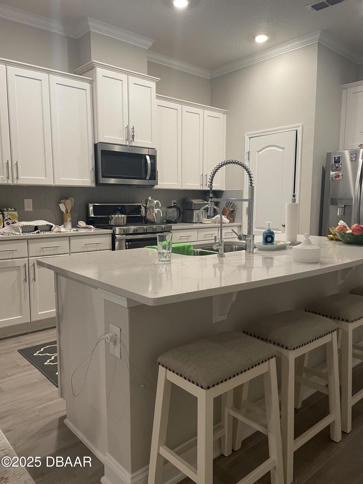 181 Thistleton Way St. Augustine, FL 32092 - Photo 7 of 31 a kitchen with a sink and cabinets