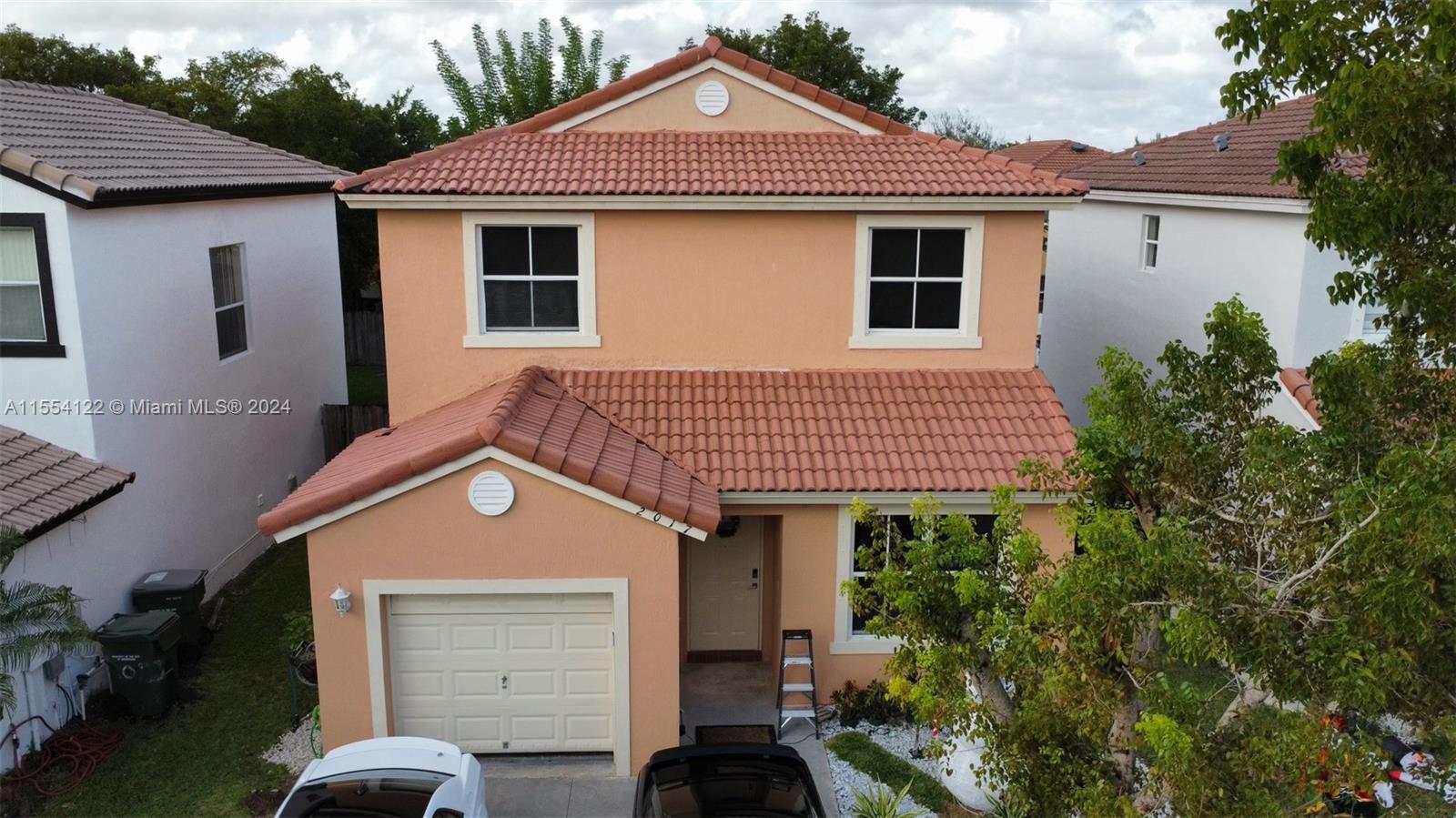2017 Southeast 15th Street Homestead, FL 33035 - Photo 1 of 20 a front view of a house with a yard