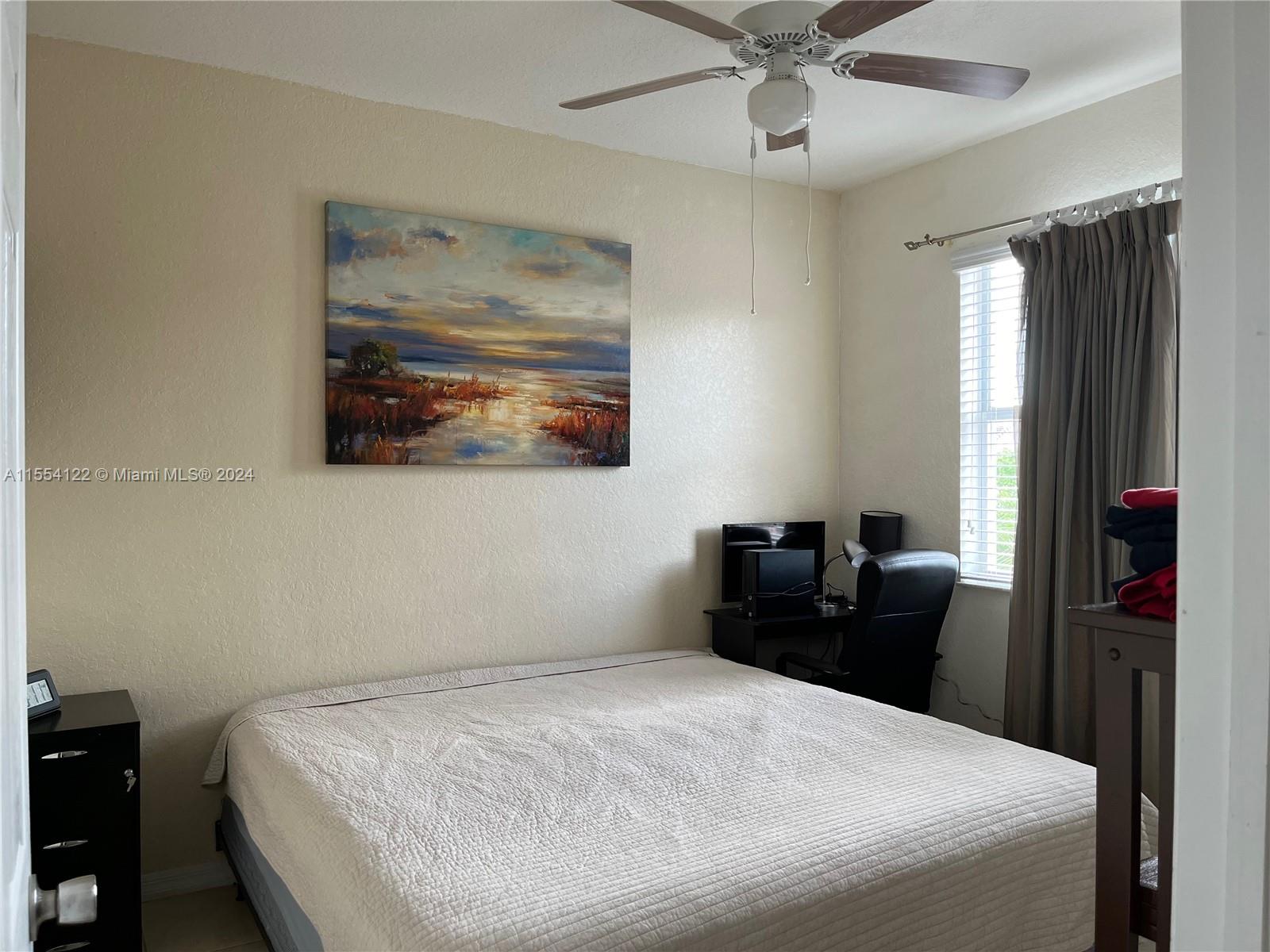 2017 Southeast 15th Street Homestead, FL 33035 - Photo 11 of 20 a bedroom with a bed and a chandelier