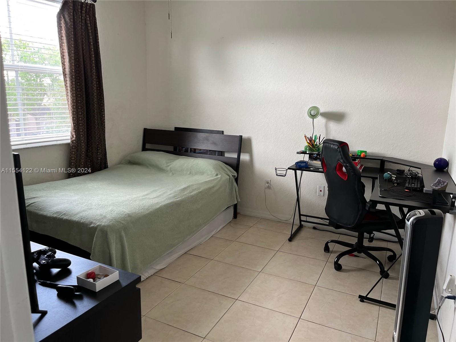 2017 Southeast 15th Street Homestead, FL 33035 - Photo 12 of 20 a bedroom with a bed and a desk