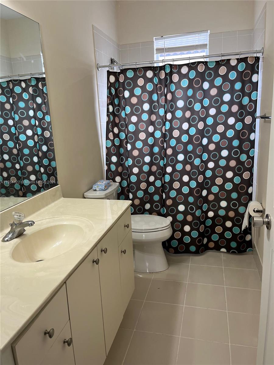 2017 Southeast 15th Street Homestead, FL 33035 - Photo 13 of 20 a bathroom with a sink toilet and shower