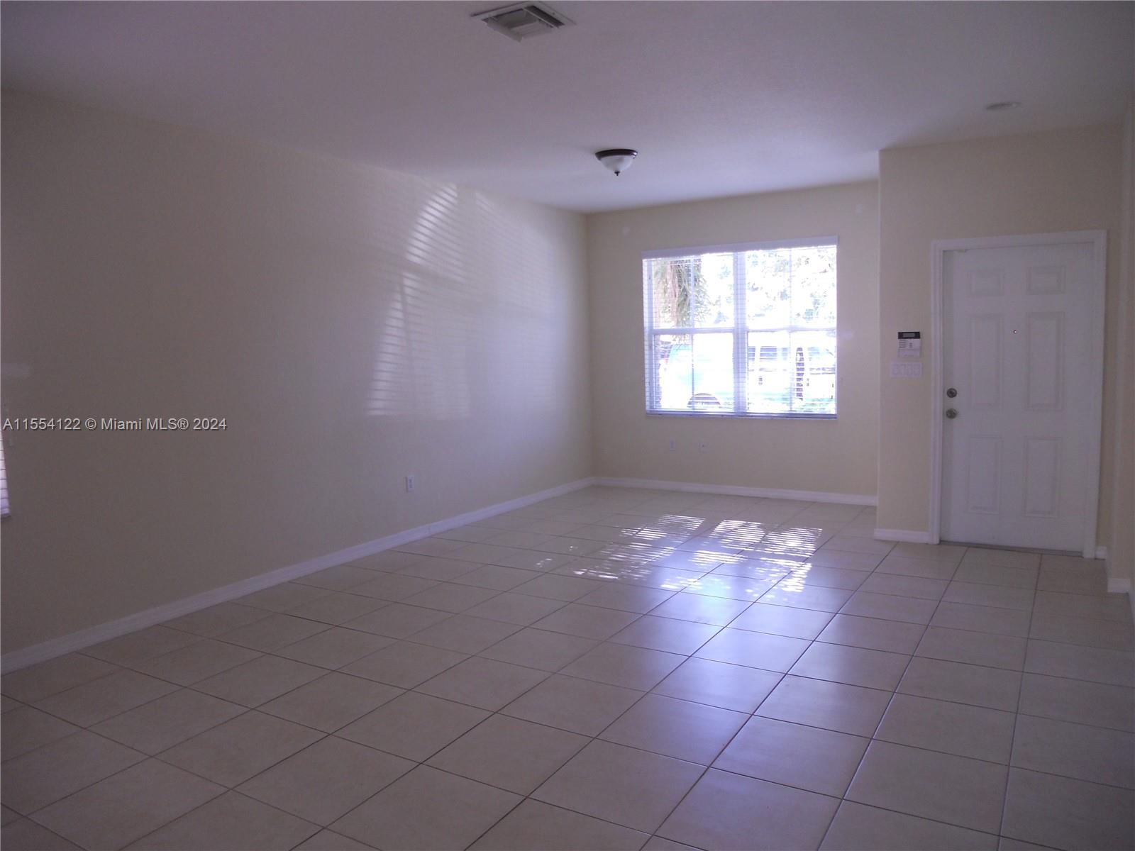 2017 Southeast 15th Street Homestead, FL 33035 - Photo 2 of 20 a view of an empty room with a window