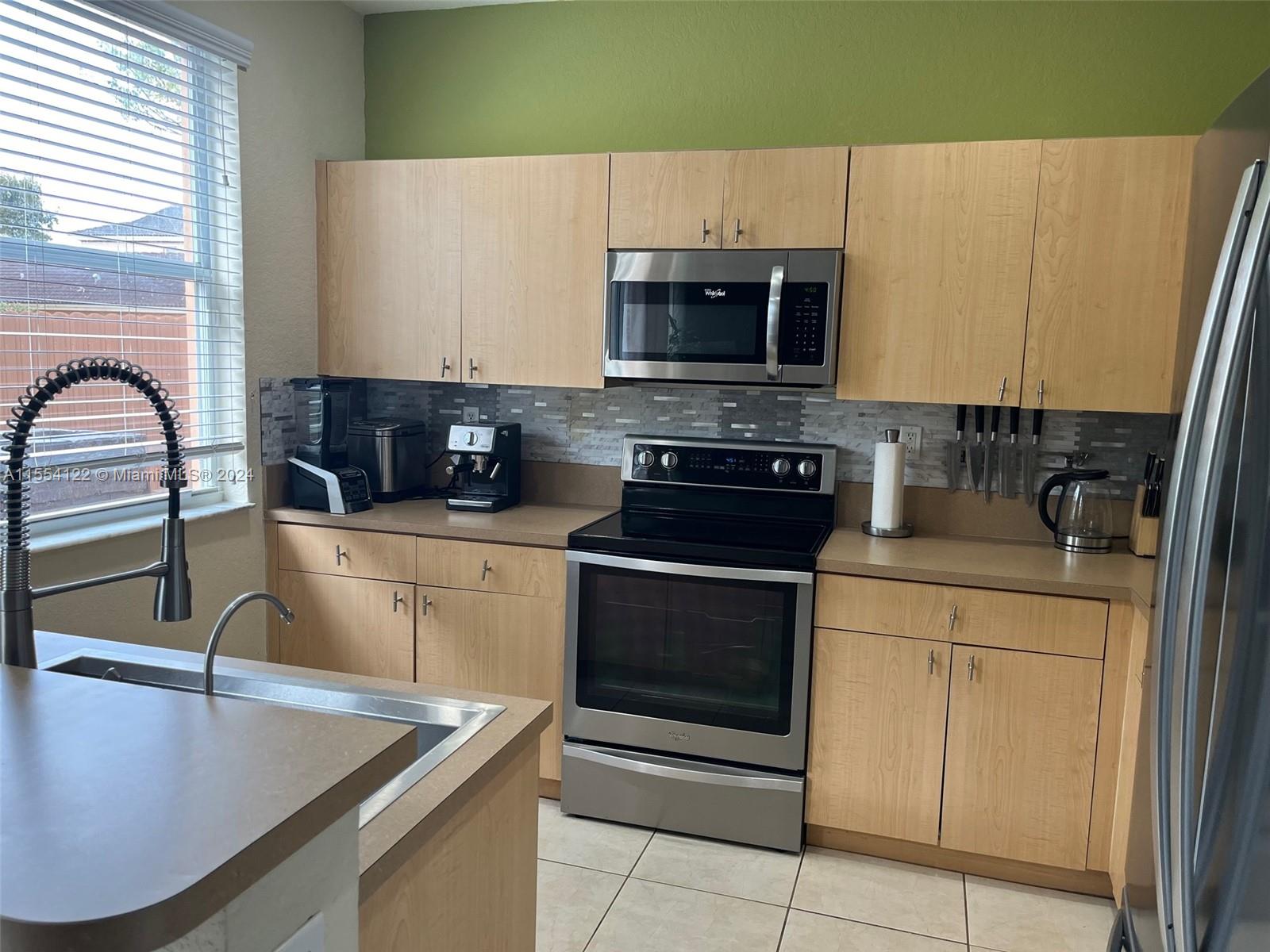 2017 Southeast 15th Street Homestead, FL 33035 - Photo 3 of 20 a kitchen with a sink a stove and cabinets