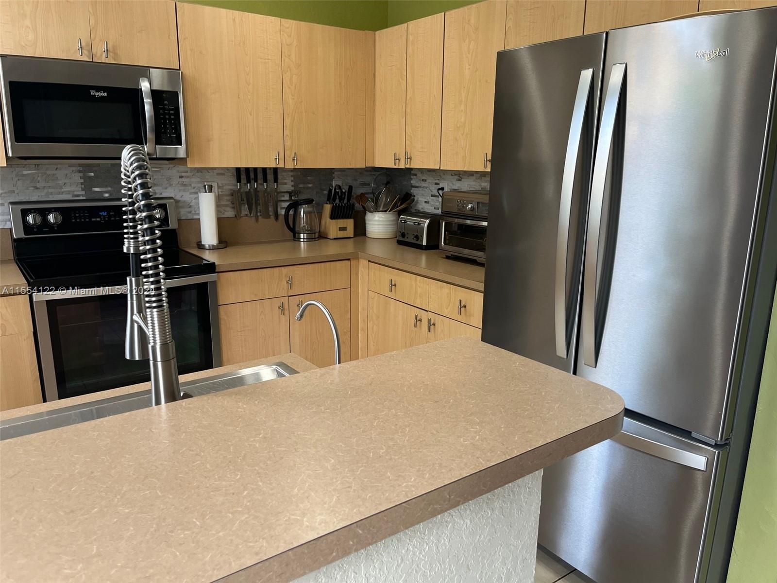 2017 Southeast 15th Street Homestead, FL 33035 - Photo 4 of 20 a kitchen with stainless steel appliances a refrigerator sink and microwave