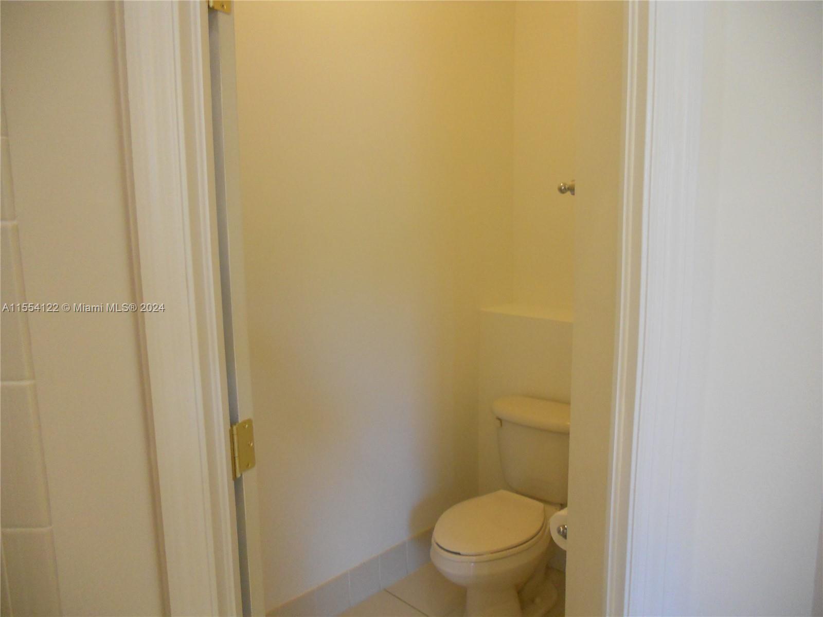 2017 Southeast 15th Street Homestead, FL 33035 - Photo 5 of 20 a white toilet sitting next to a shower