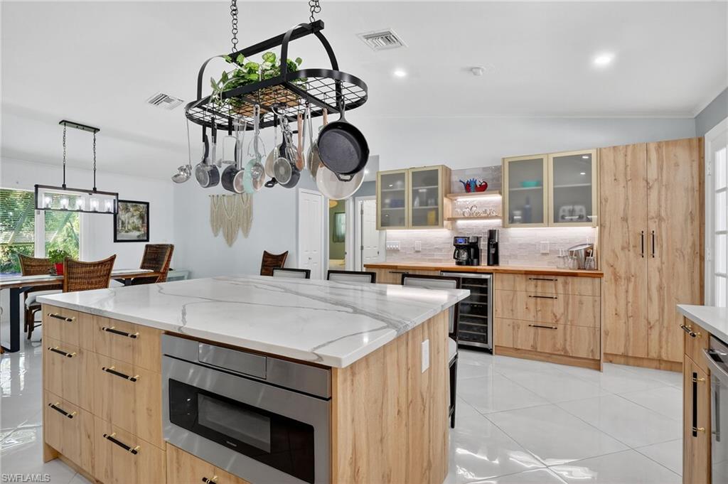 410 6th Street Northeast Naples, FL 34120 - Photo 17 of 32 Seller added spacious pantry and expanded island storage in the kichen remodel.