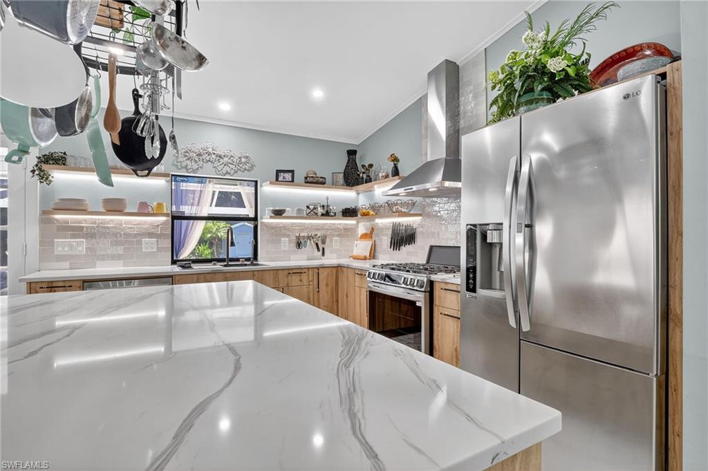 410 6th Street Northeast Naples, FL 34120 - Photo 18 of 32 Beautiful gleaming quartz countertops and gorgeous backsplash make this kitchen a show stopper!