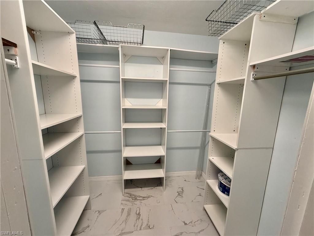 410 6th Street Northeast Naples, FL 34120 - Photo 27 of 32 2nd master closet is a walk-in with built in shelving.