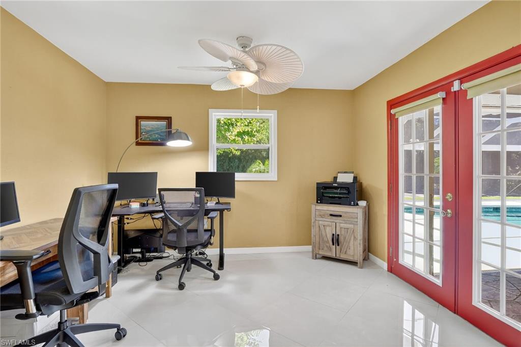410 6th Street Northeast Naples, FL 34120 - Photo 29 of 32 Den/guest room with ceiling fan and double french doors to the pool area.