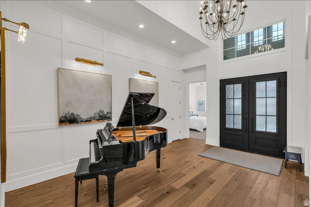 2608 Canyon Ridge Drive St. George, UT 84770 - Photo 5 of 86 Grand foyer entry featuring double front doors with textured glass, expansive wood-finish flooring, and a two-story ceiling with a chandelier