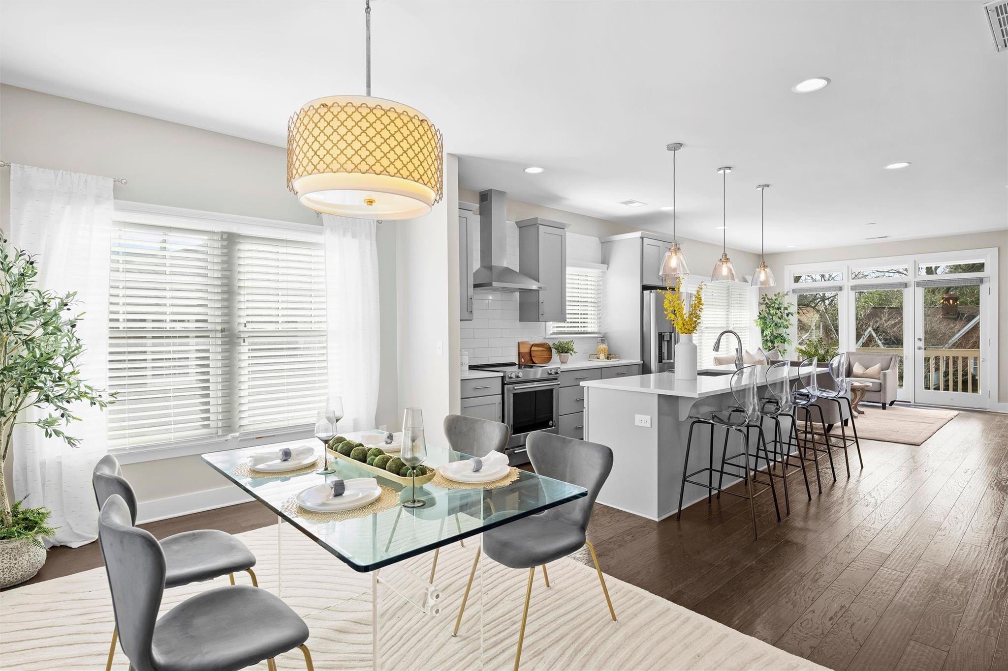 a kitchen with granite countertop a table and chairs in it