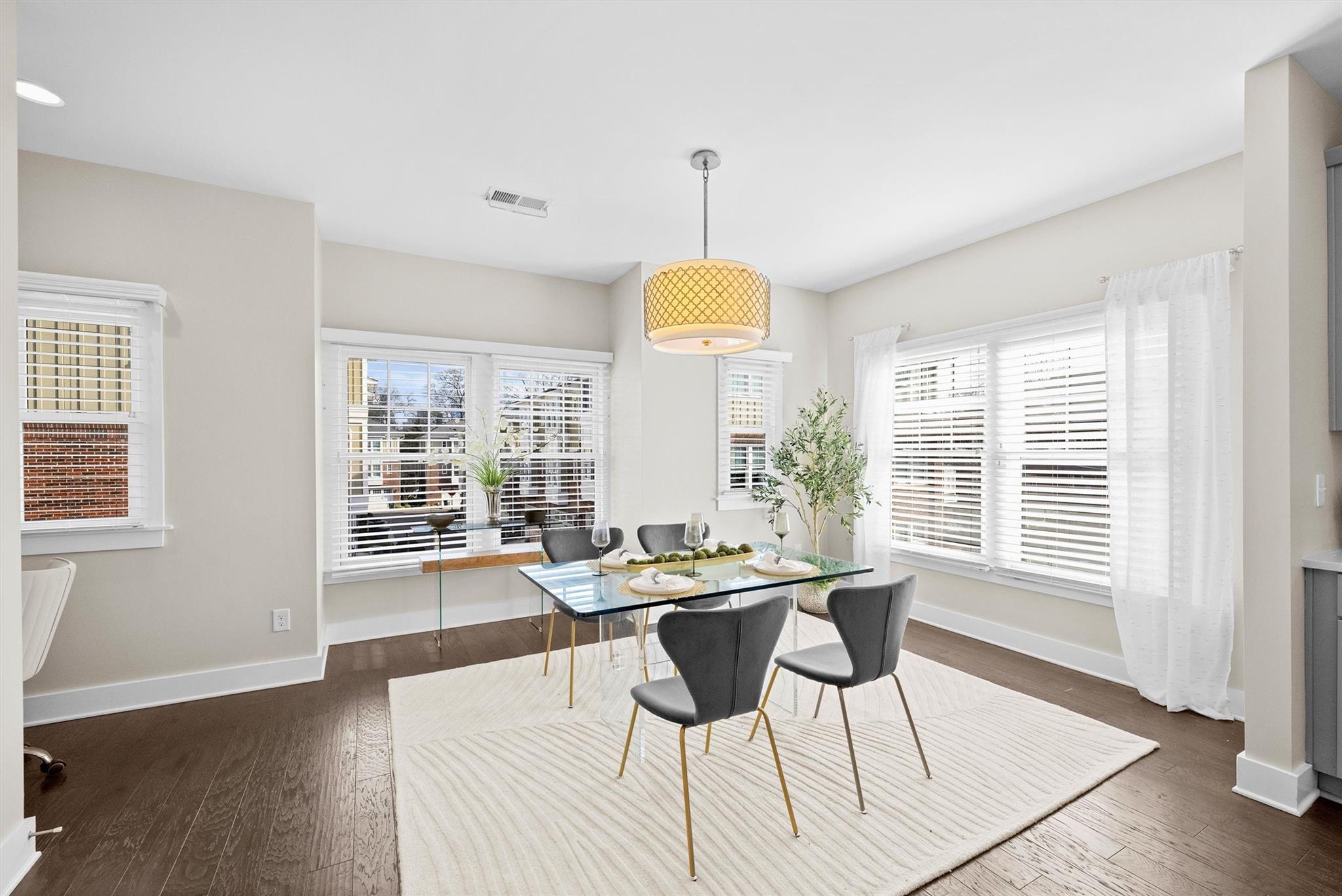 131 Grandin Road Charlotte, NC 28208 - Photo 22 of 45 a dining hall with couches a dining table and chairs with wooden floor