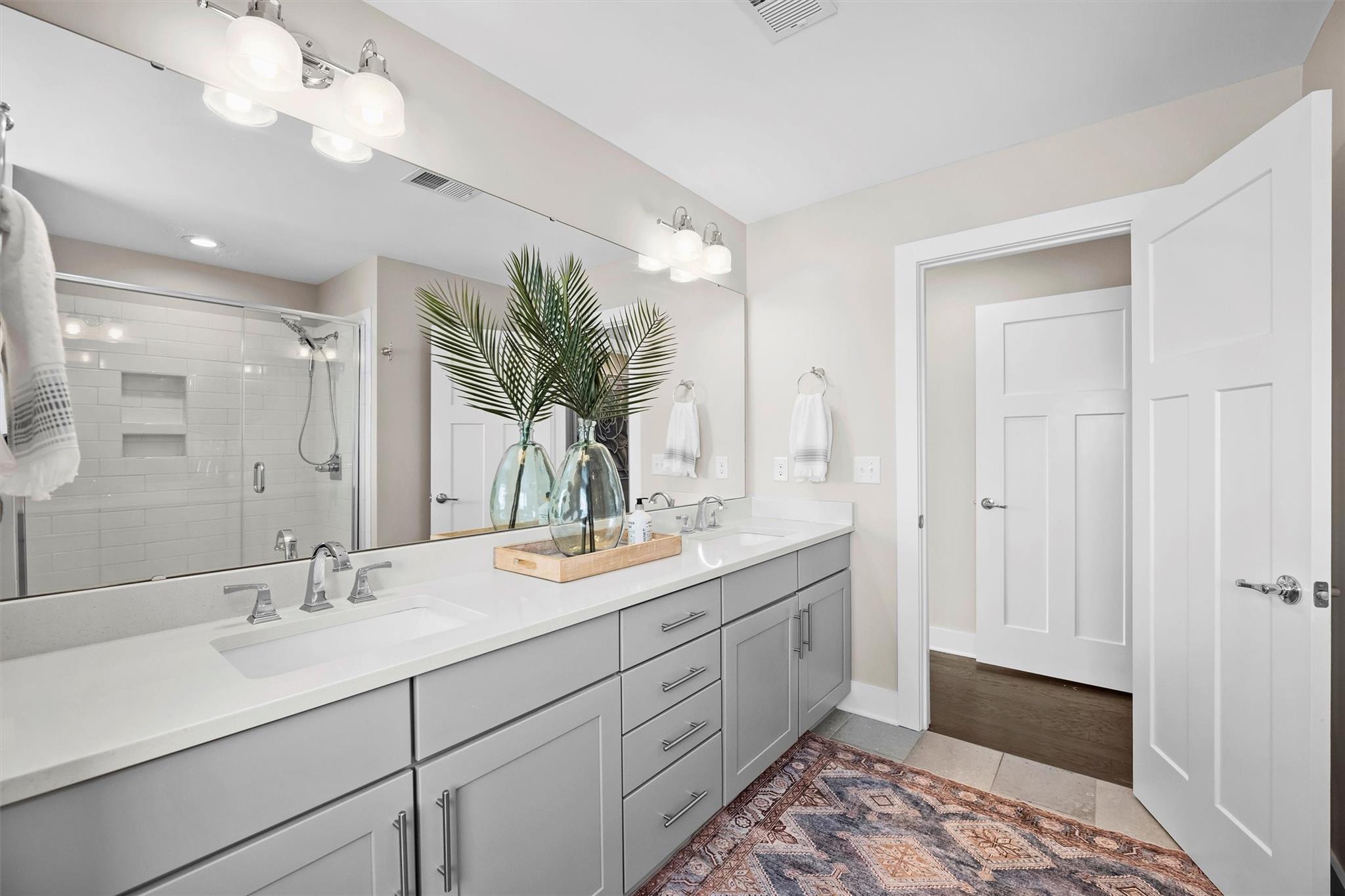 131 Grandin Road Charlotte, NC 28208 - Photo 34 of 45 a spacious bathroom with a double vanity sink mirror and next to a window