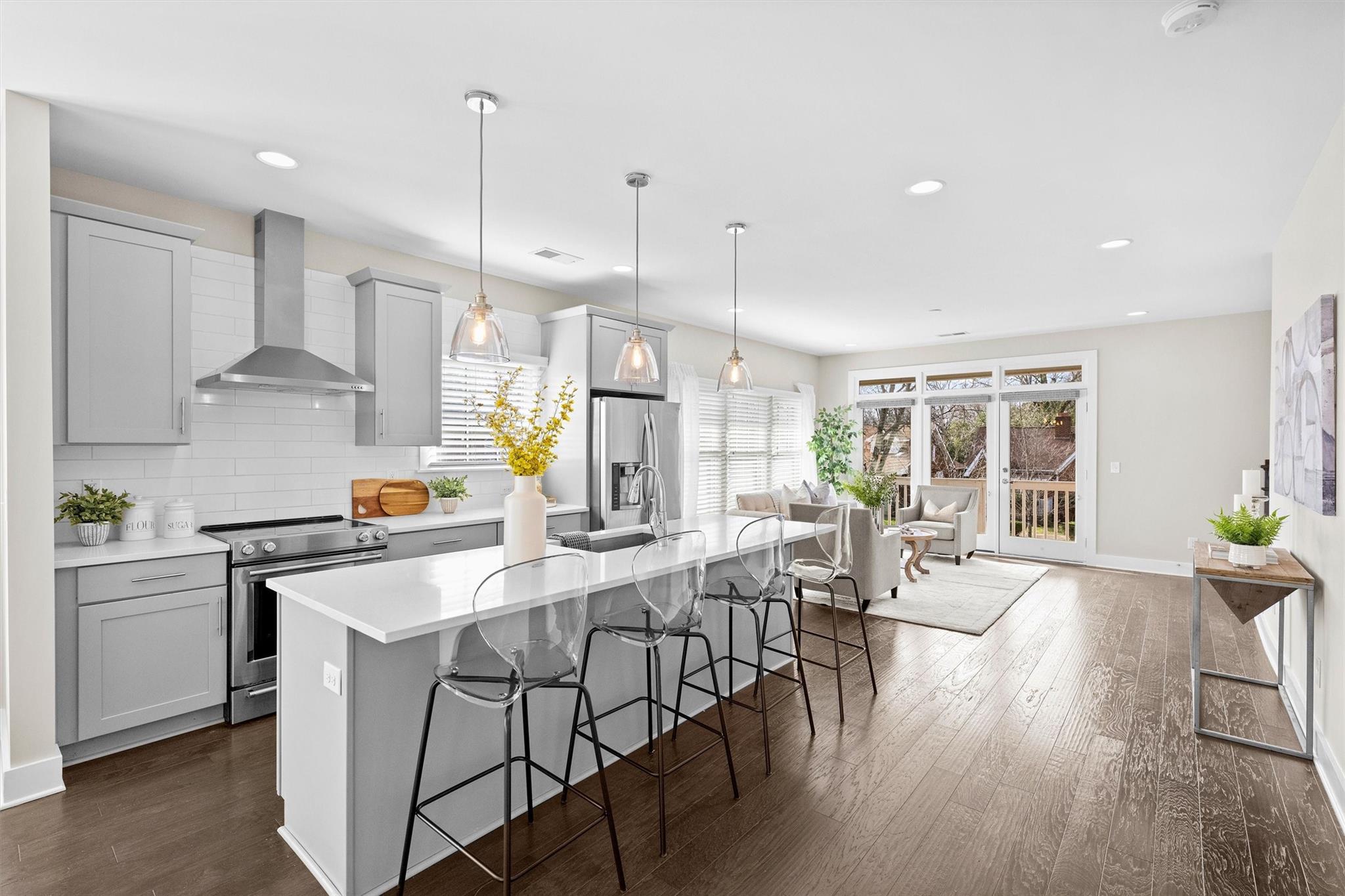 131 Grandin Road Charlotte, NC 28208 - Photo 10 of 45 a kitchen with stainless steel appliances a dining table chairs stove a refrigerator and cabinets