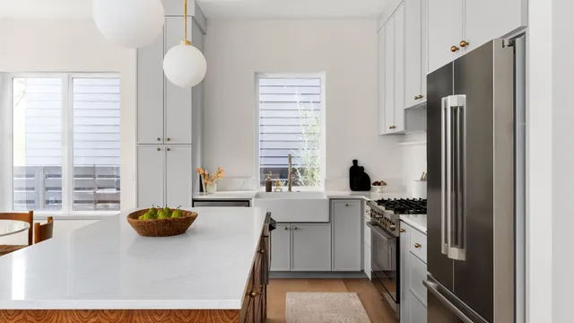 a kitchen with stainless steel appliances a center island and a refrigerator