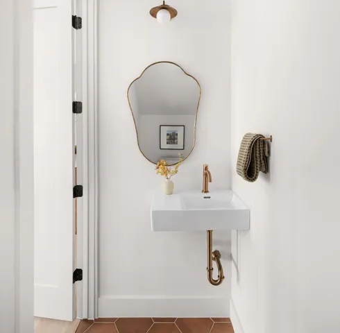 a bathroom with a sink and mirror