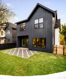 a view of an house with backyard and fireplace