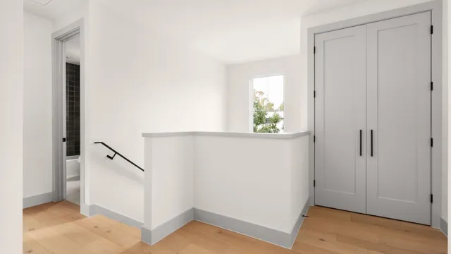 a view of an entryway with wooden floor