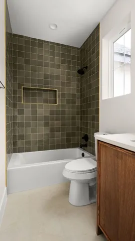 a bathroom with a white toilet sitting next to a window