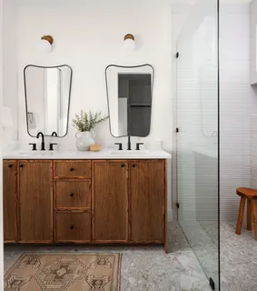 a bathroom with a double vanity sink and a mirror