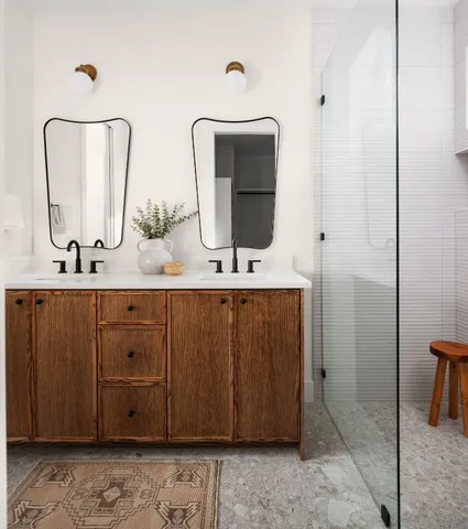 a bathroom with a double vanity sink and a mirror