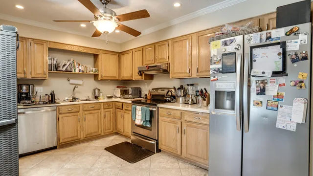 a kitchen with stainless steel appliances granite countertop a refrigerator sink and cabinets