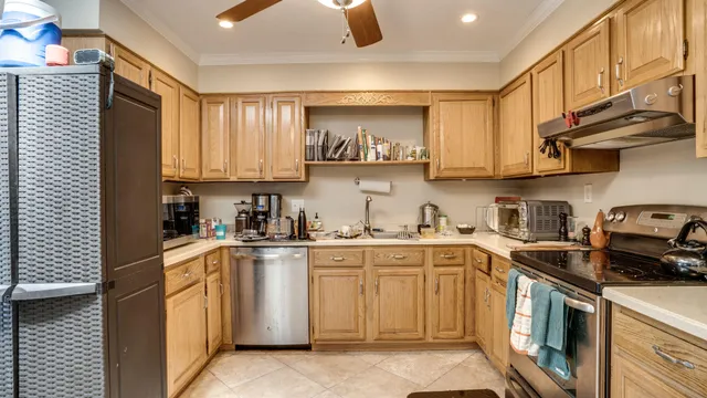 a kitchen with stainless steel appliances granite countertop a sink and cabinets