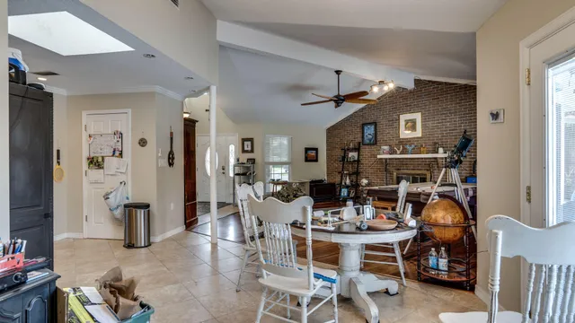 a view of a dining room with furniture and chandelier