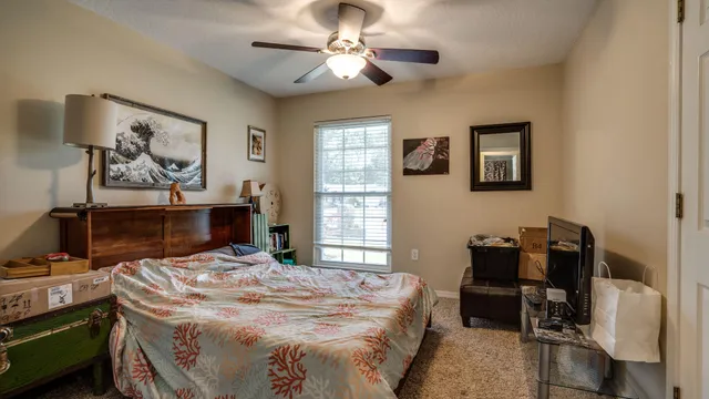 a bedroom with a bed and a chandelier