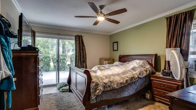 a bedroom with a bed closet and flat tv screen