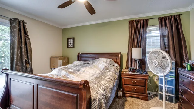 a bed sitting in a bedroom next to a window