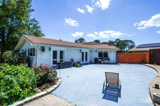 a front view of a house with yard and seating area