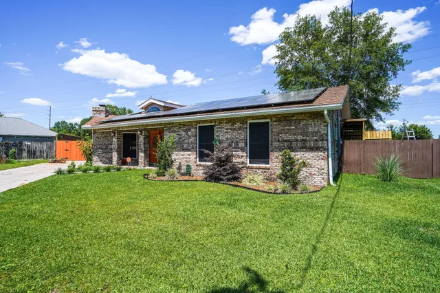 a view of a house with backyard porch and garden