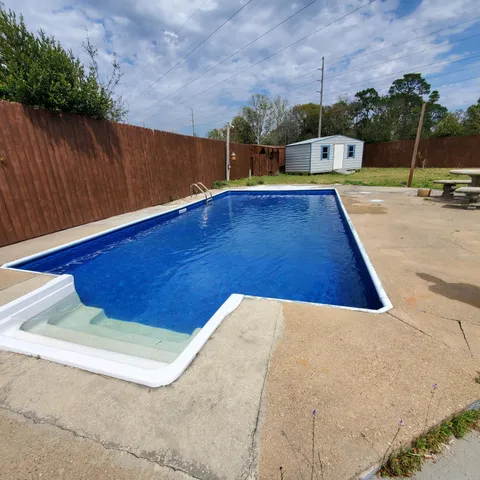 a view of a swimming pool with an outdoor space and seating area
