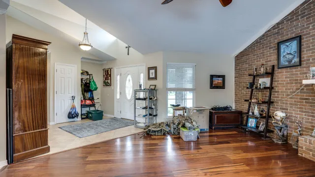a living room with furniture and wooden floor