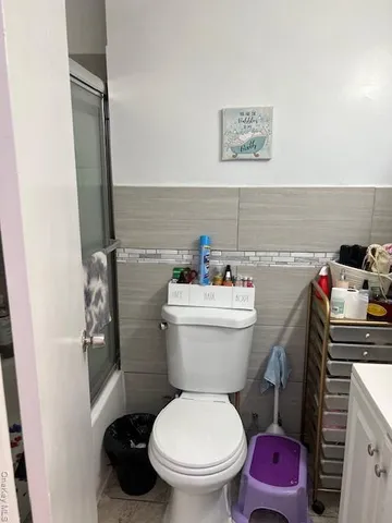 a bedroom with a bed and a chair