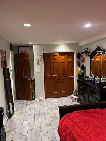 a bedroom with a bed and a mirror