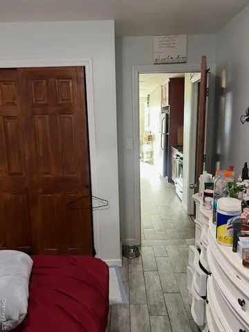 a bedroom with furniture and a mirror