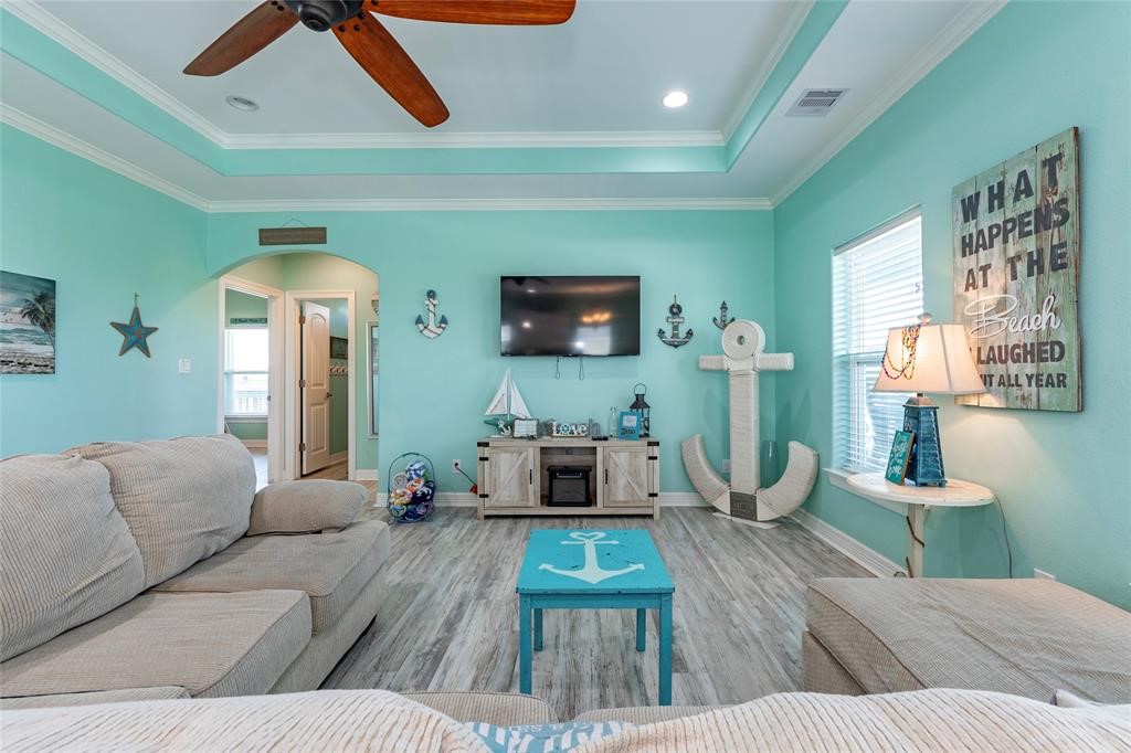 987 Surf Crystal Beach Crystal Beach, TX 77650 - Photo 13 of 45 a living room with furniture and a wooden floor