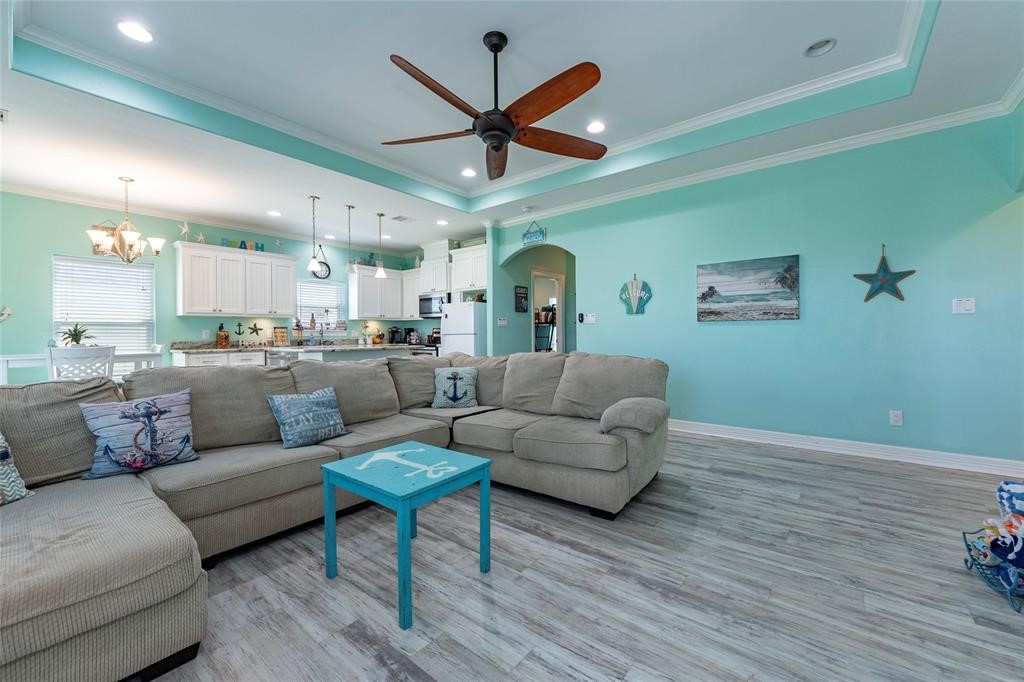 987 Surf Crystal Beach Crystal Beach, TX 77650 - Photo 15 of 45 a living room with furniture kitchen view and a wooden floor