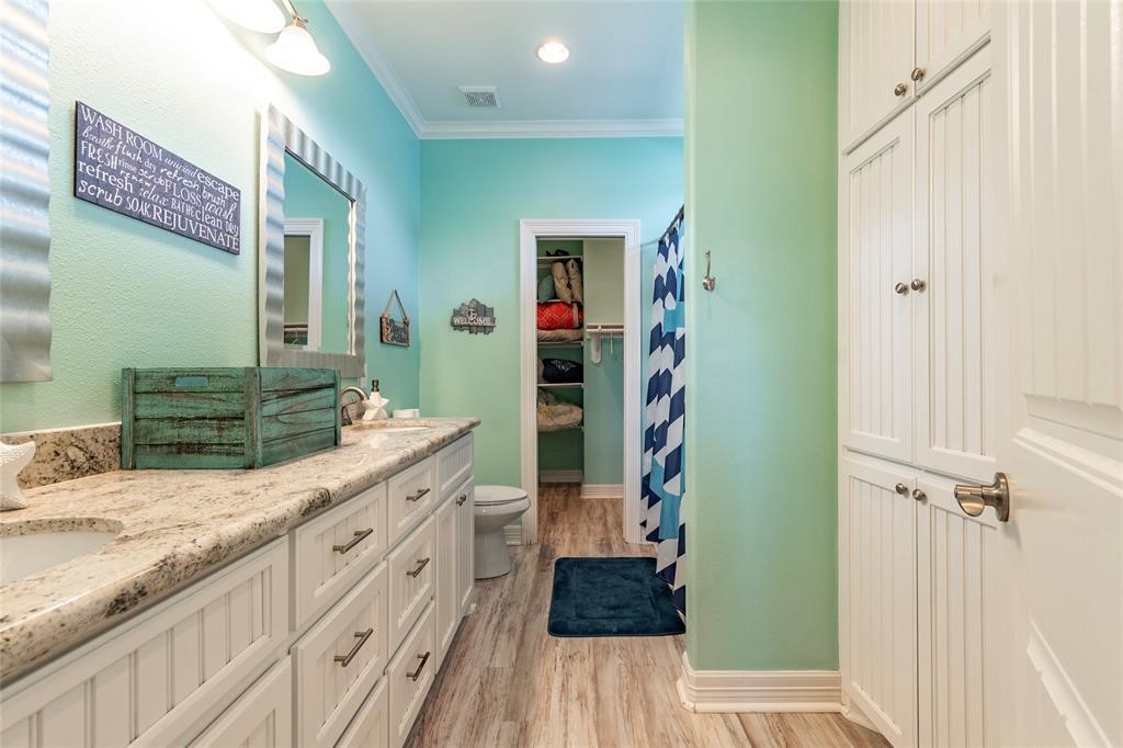 987 Surf Crystal Beach Crystal Beach, TX 77650 - Photo 20 of 45 a spacious bathroom with a granite countertop sink a mirror and shower