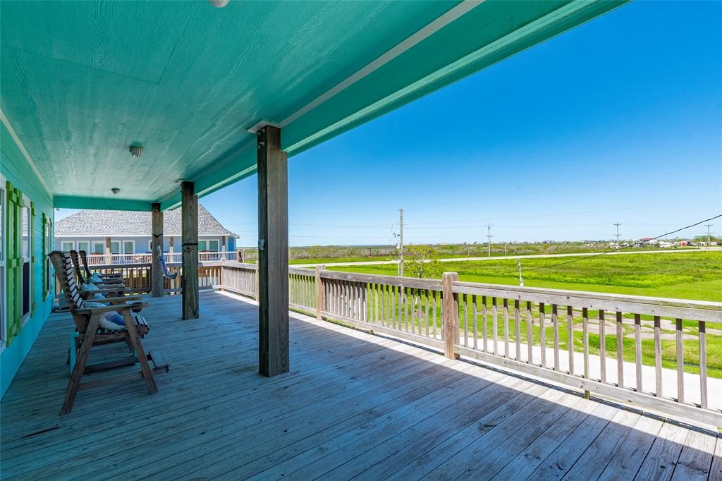 987 Surf Crystal Beach Crystal Beach, TX 77650 - Photo 27 of 45 a view of a chairs and table on the wooden deck